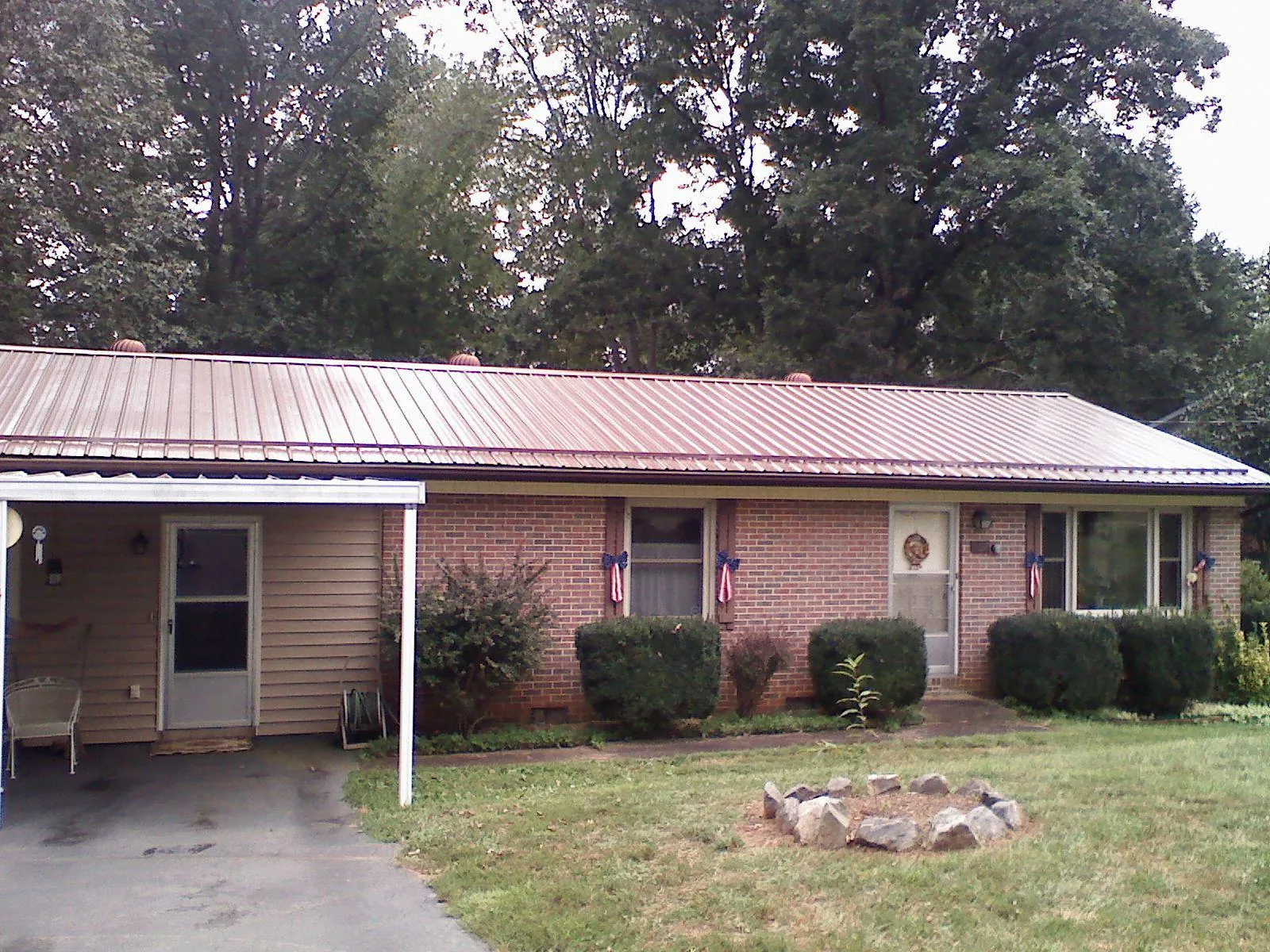 Bronze metal roof and carport on a brick ranch home — Roof Repair work by our crew in Fairless Hills